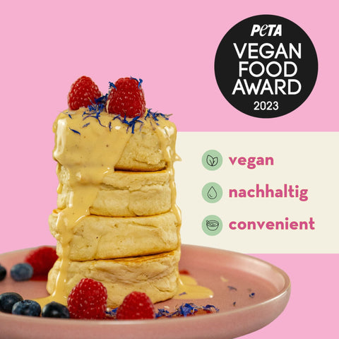 Stapel Pancakes mit Toppings, daneben der PETA Vegan Food Award 2023 und die Claims 'vegan', 'nachhaltig', 'convenient'.